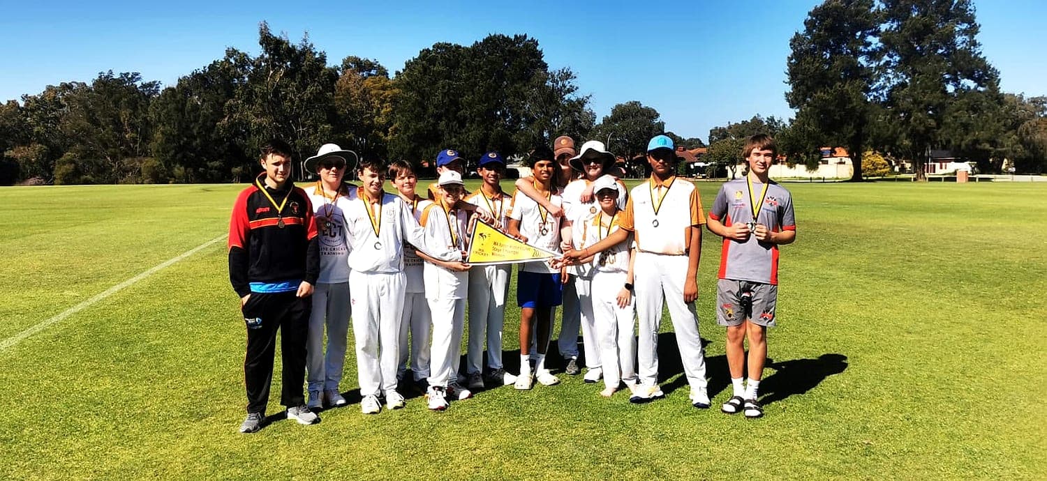 The RUNS XI squad with their medals, holding the WA junior winter cricket winners pennant